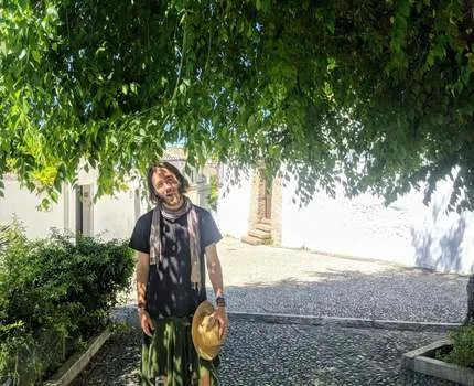 Man standing outside underneath a tree